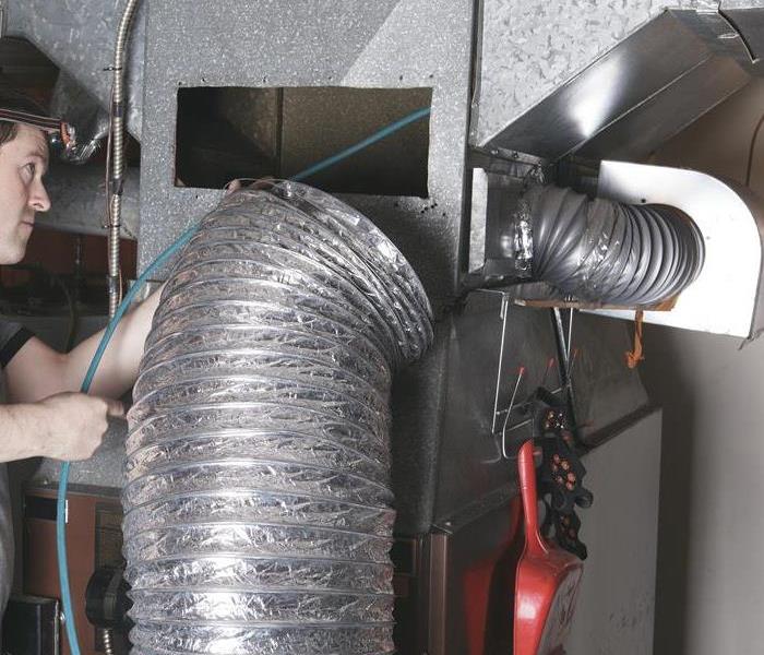 Duct work with technician inspecting