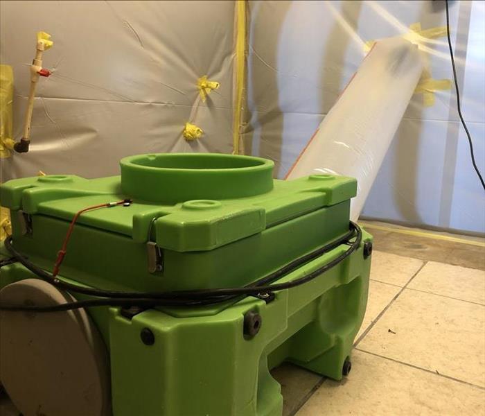 Green air scrubber ducted into plastic containment